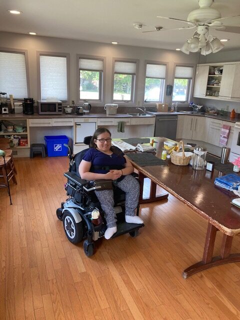 Photo of a resident wheelchair user in the kitchen area of Deborah's Home
